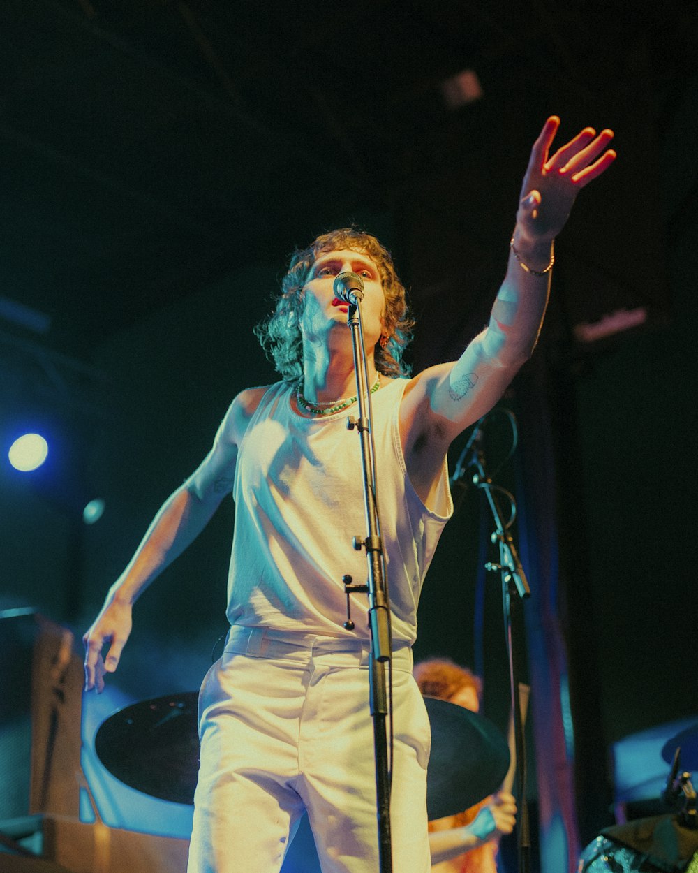 a man standing on a stage holding a microphone