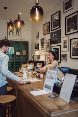 a man and a woman standing at a bar