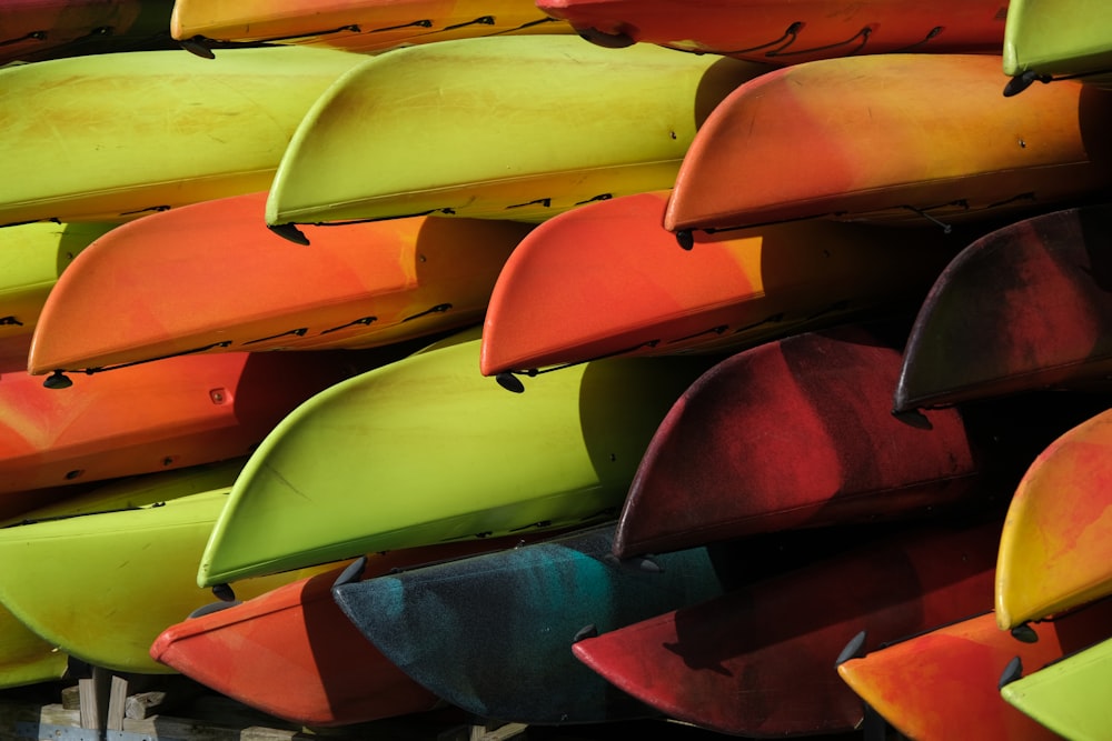 a bunch of colorful surfboards stacked on top of each other