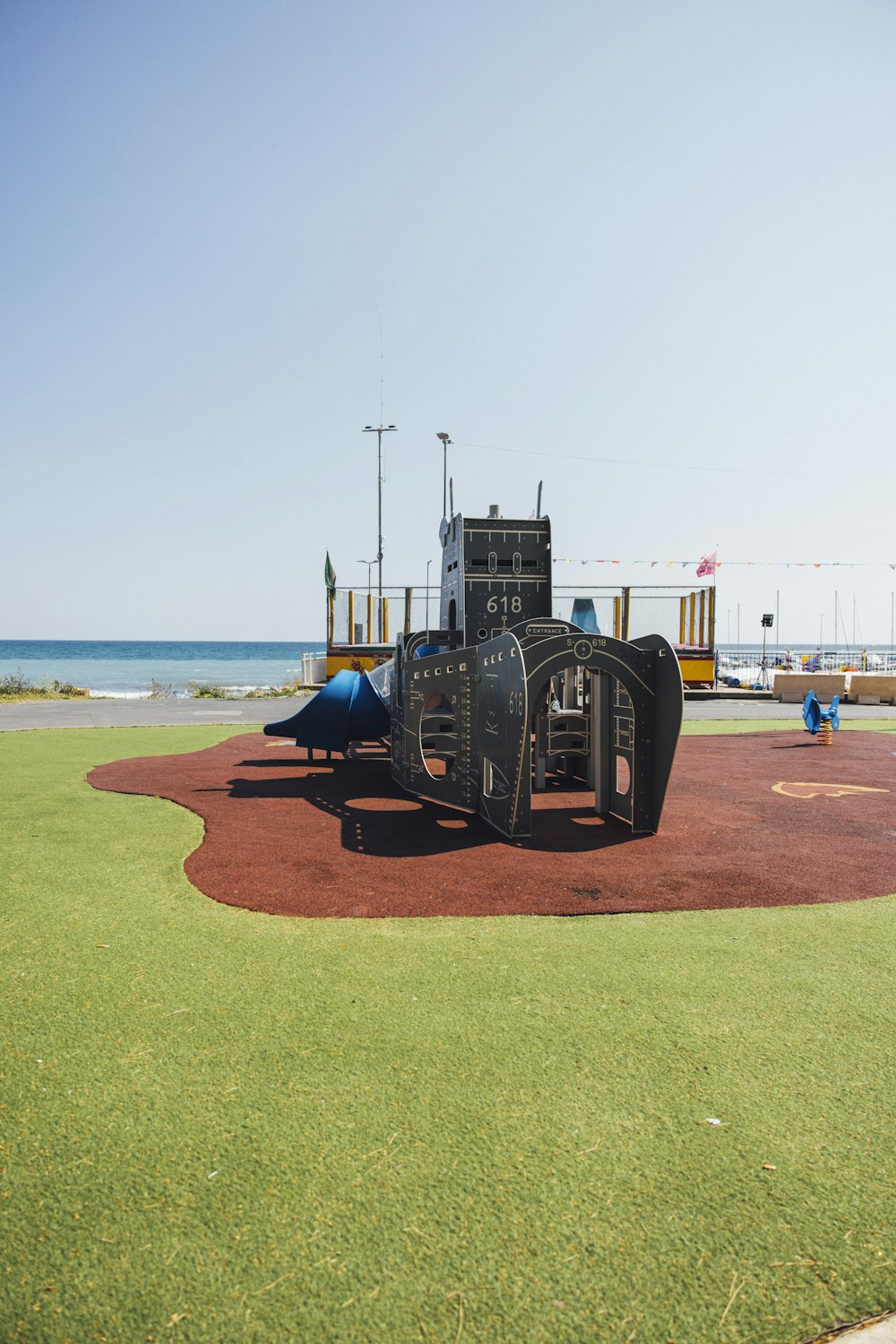 a children's play area with a slide in the background