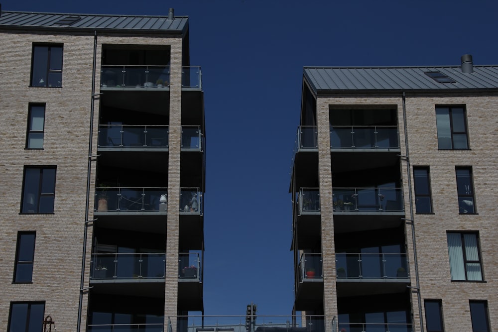 two tall brick buildings with balconies and balconies