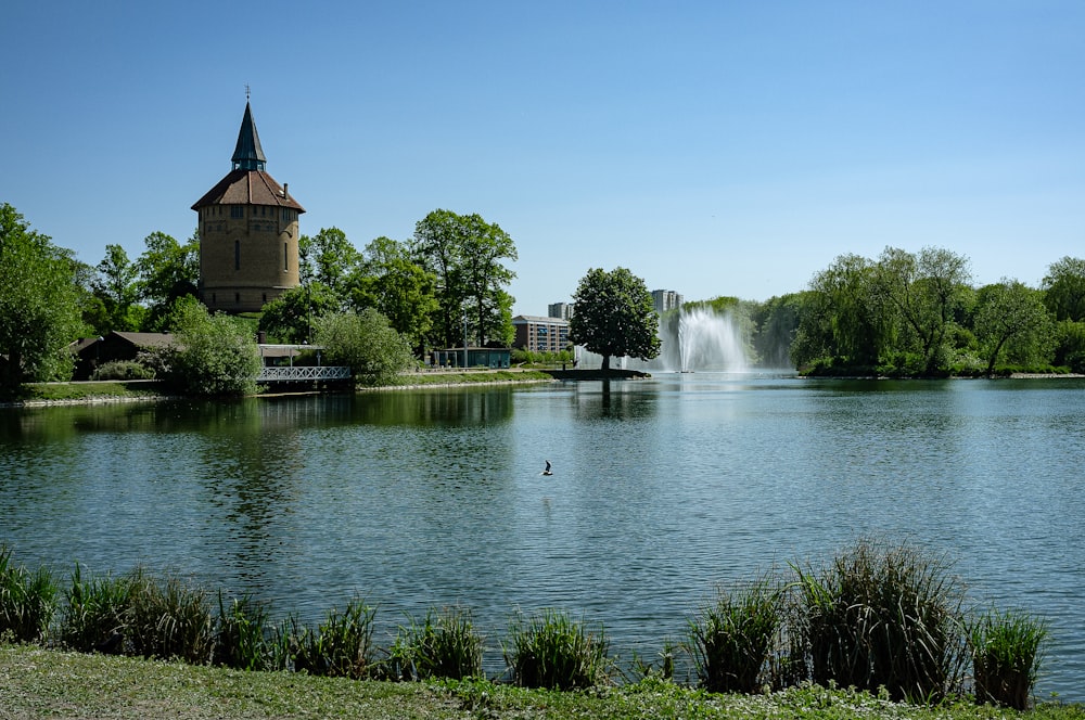 a lake with a fountain in the middle of it