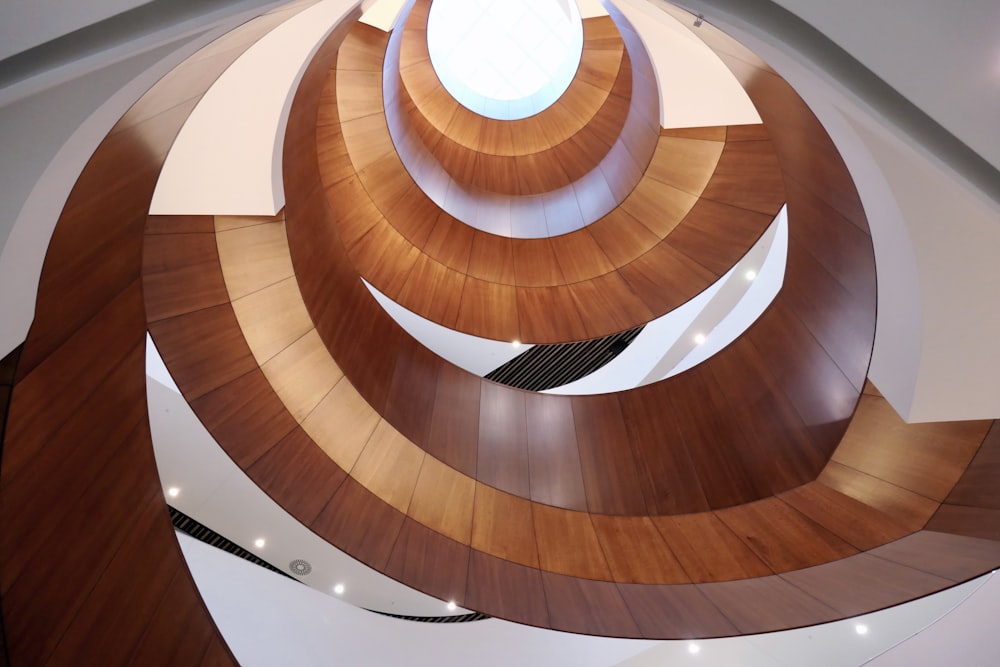 a spiral staircase in a building with a skylight