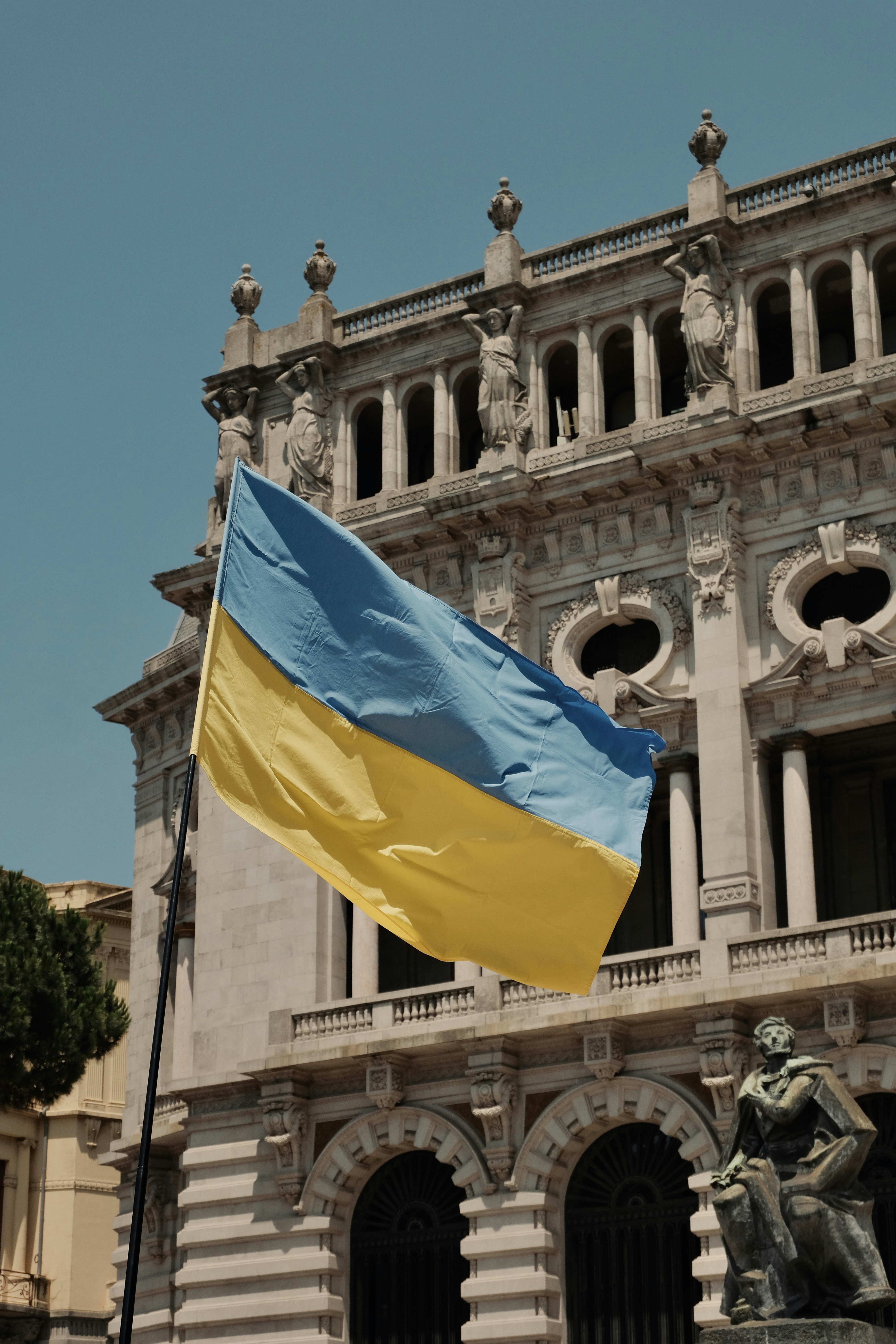 a flag flying in front of a building