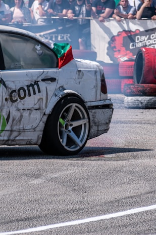 Crowd cheering as vaqueiro performs a tight drift maneuver during a competition.