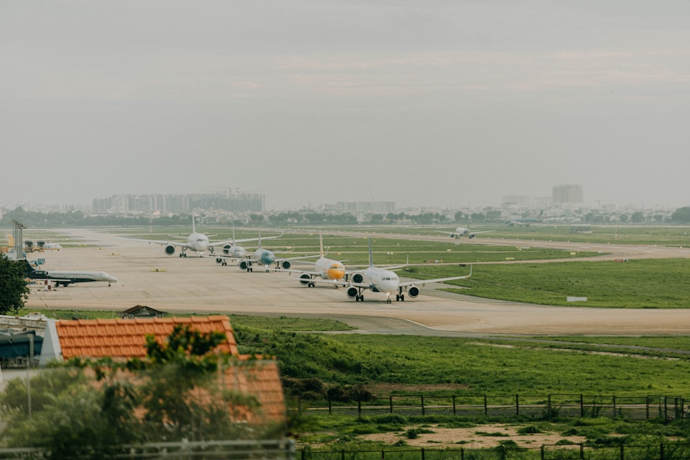 a row of airplanes parked on a runway