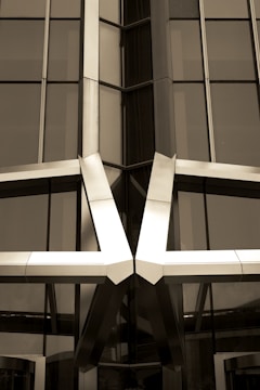 Close-up of a polished metal structure framing a contemporary storefront.