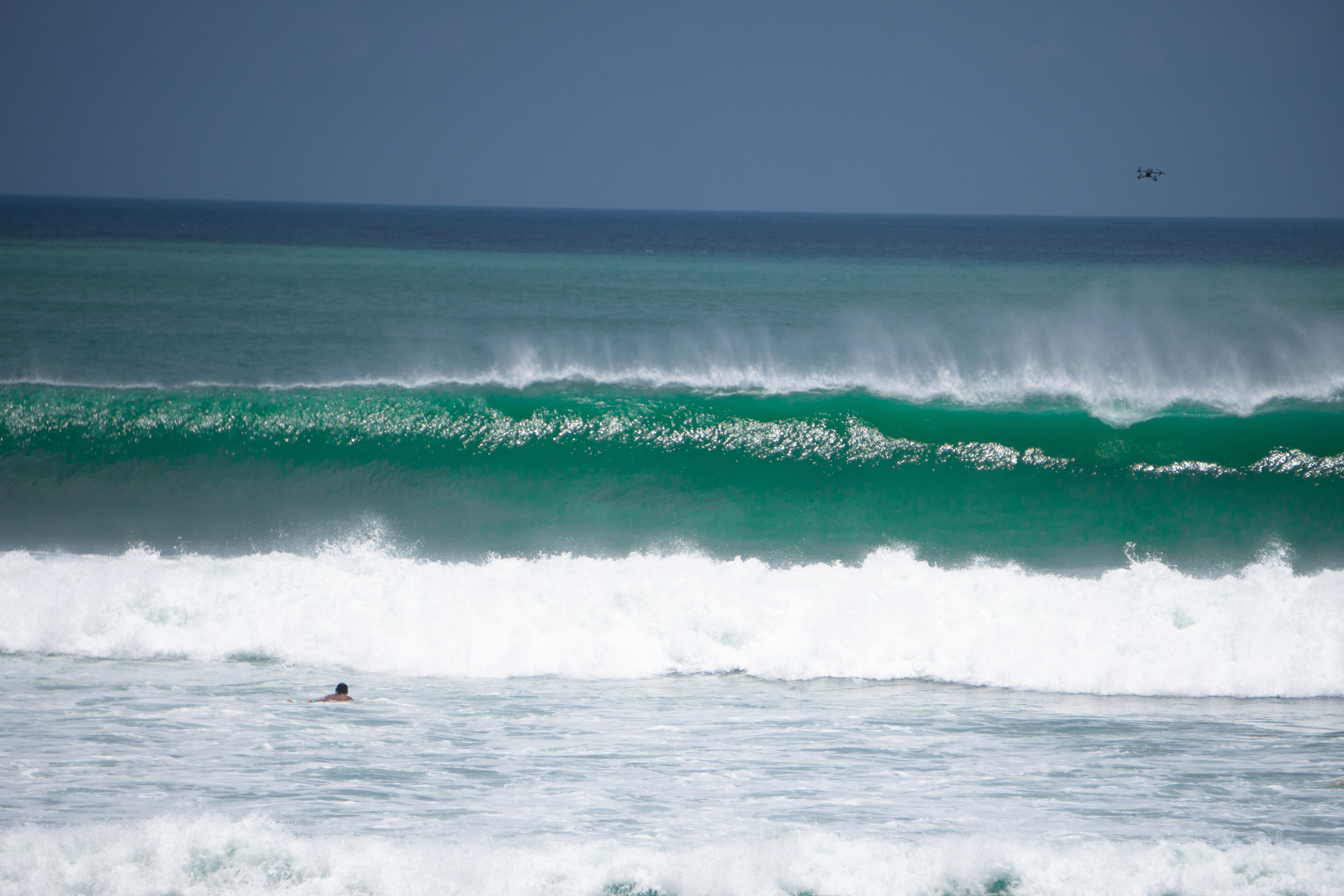 a person riding a surfboard on a wave in the ocean