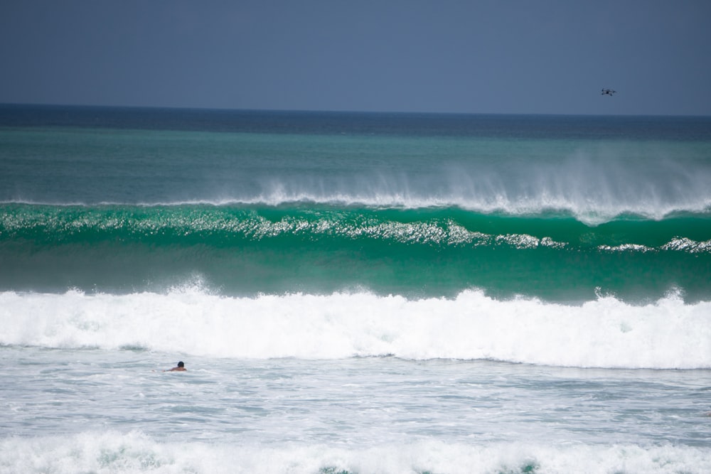 a person riding a surfboard on a wave in the ocean