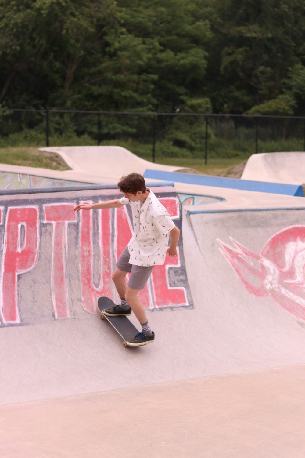a young man riding a skateboard up the side of a ramp