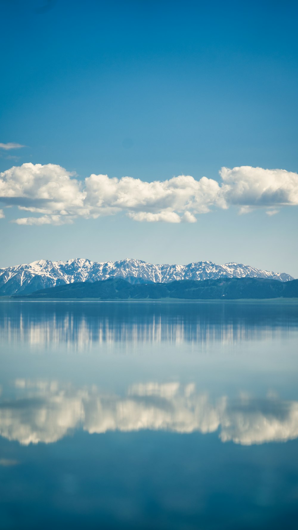 a large body of water with mountains in the background