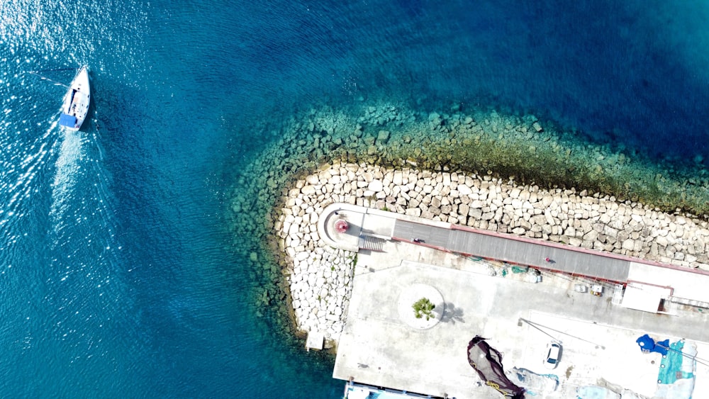 an aerial view of a boat in a body of water