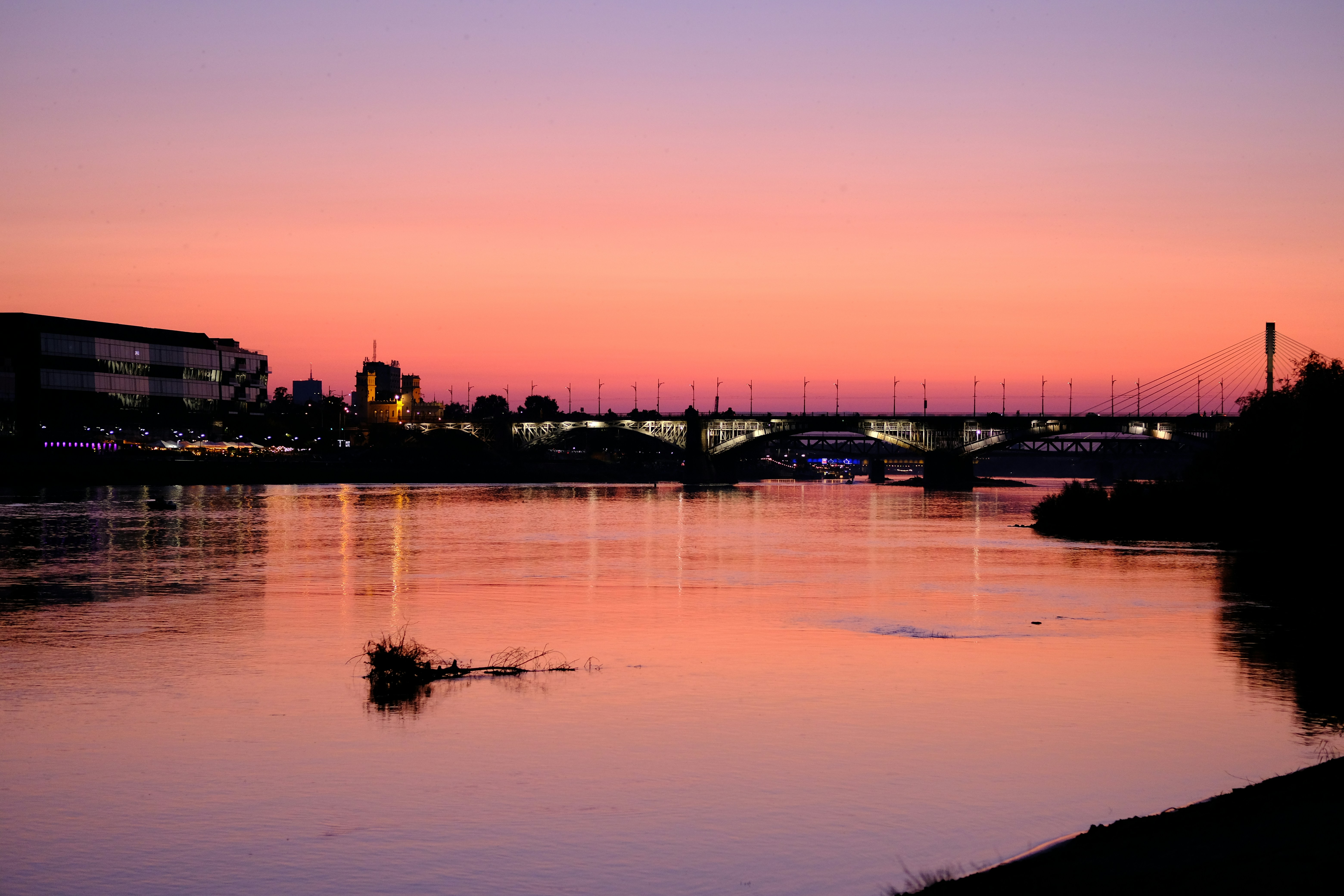 a body of water with a bridge in the background