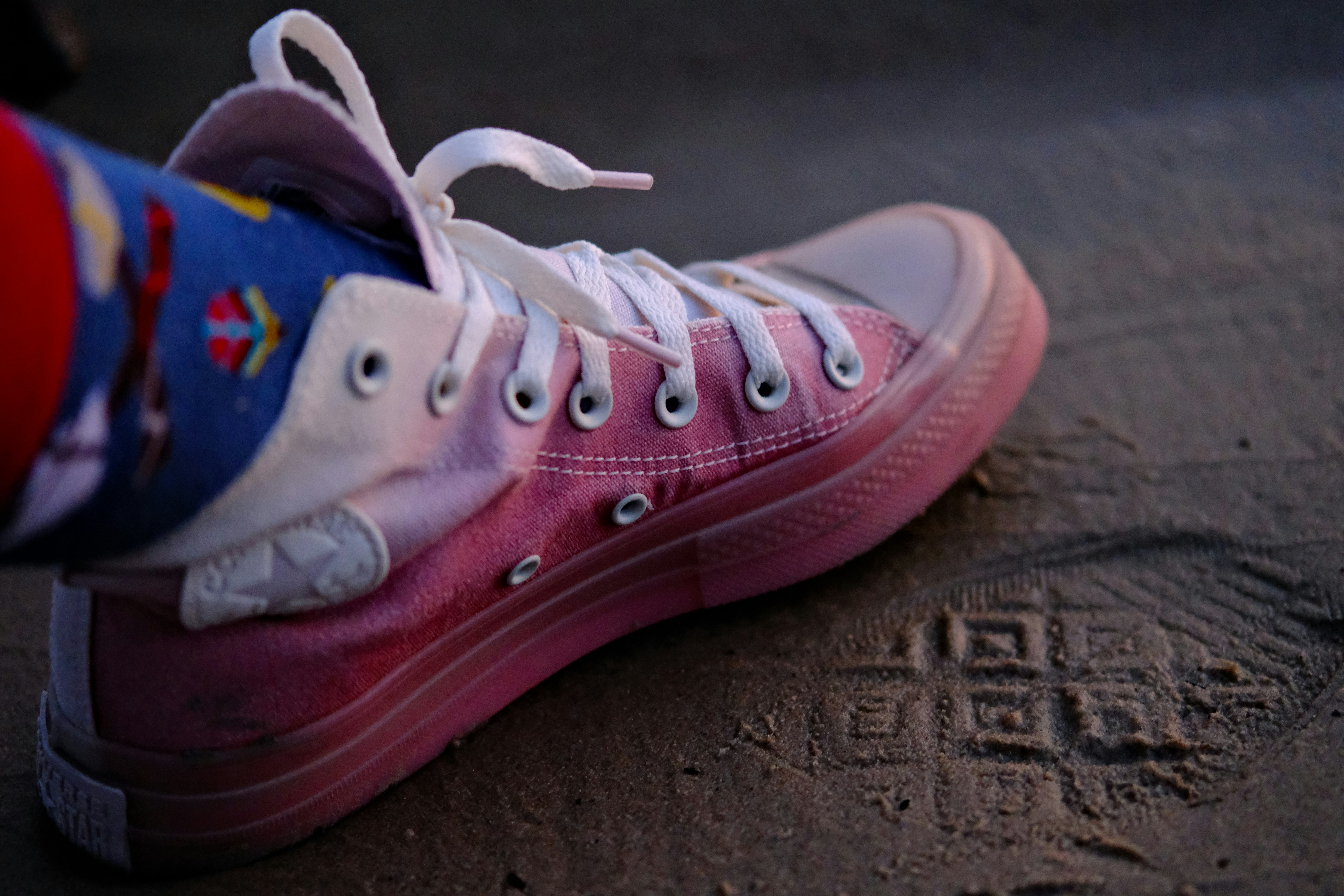 a close up of a person's shoes on the ground