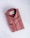 A neatly folded, striped shirt in shades of red and beige, featuring a tag with branding inside the collar. The shirt has a classic design, including buttons and a pocket detail on a smooth, neutral background.