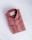 A neatly folded, striped shirt in shades of red and beige, featuring a tag with branding inside the collar. The shirt has a classic design, including buttons and a pocket detail on a smooth, neutral background.