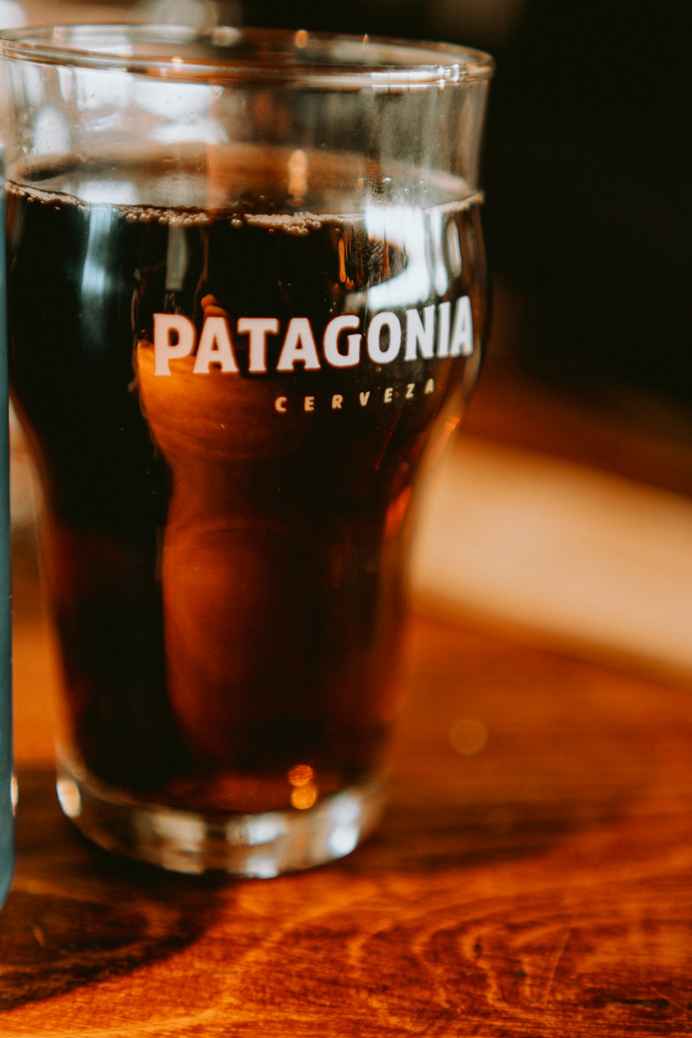 a close up of a glass of beer on a table