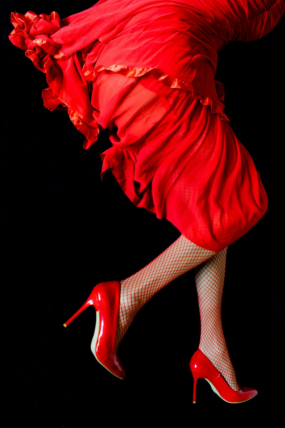 a woman in a red dress and high heels