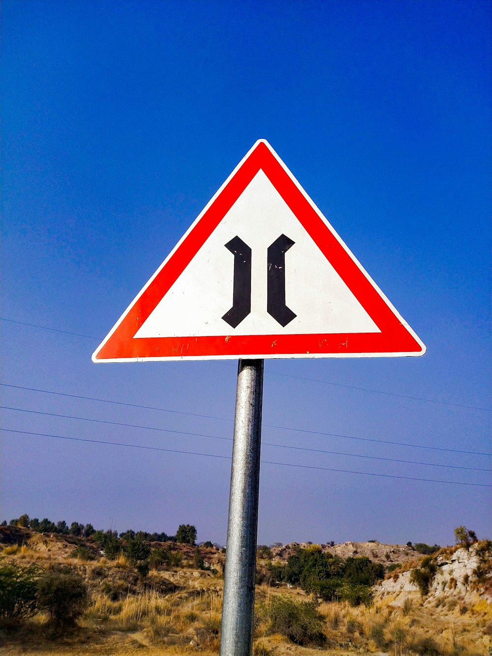 a road sign indicating the direction of the left turn