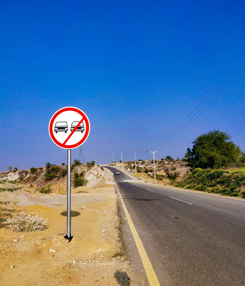 a no parking sign on the side of a road