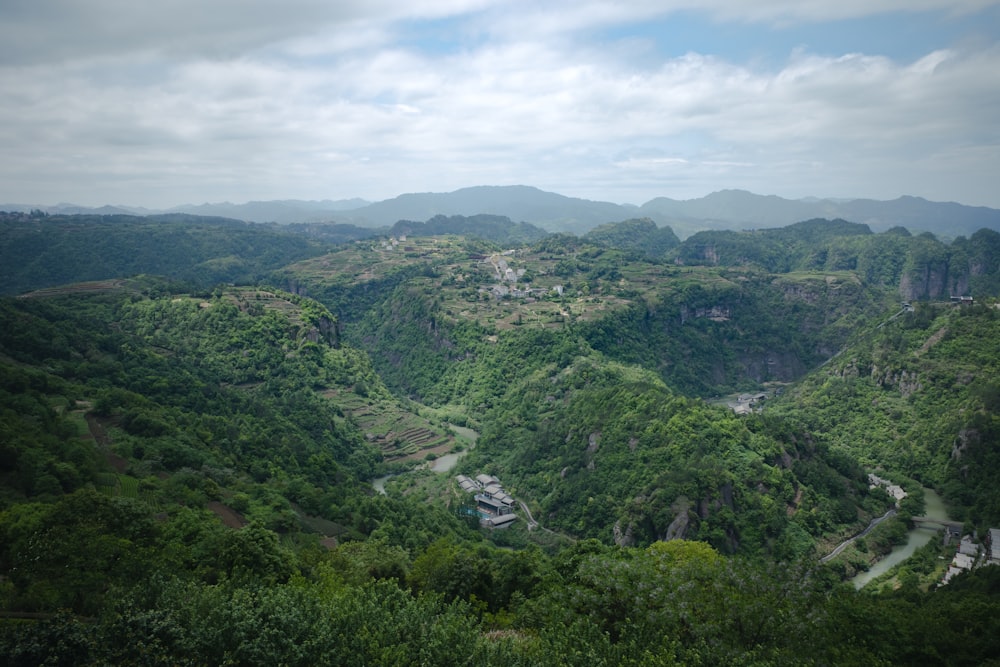 a scenic view of a valley surrounded by mountains