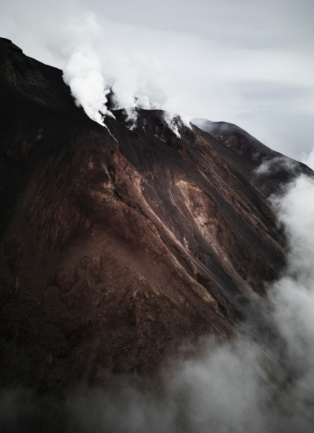 a view of a mountain with steam coming out of it