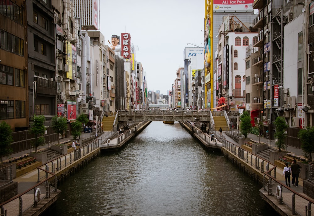 a river running through a city next to tall buildings