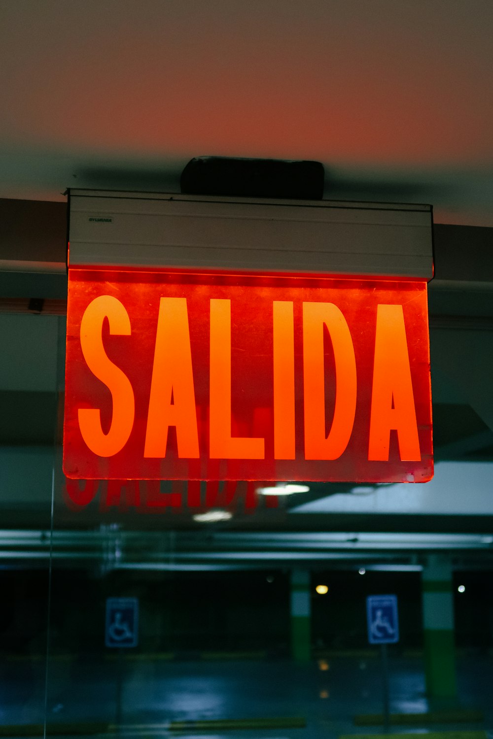 a neon sign that reads salida hanging from a ceiling