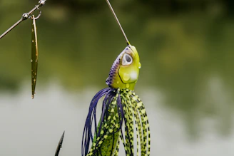 Close-up of a hand-painted wooden fishing lure with vibrant colors and detailed patterns.