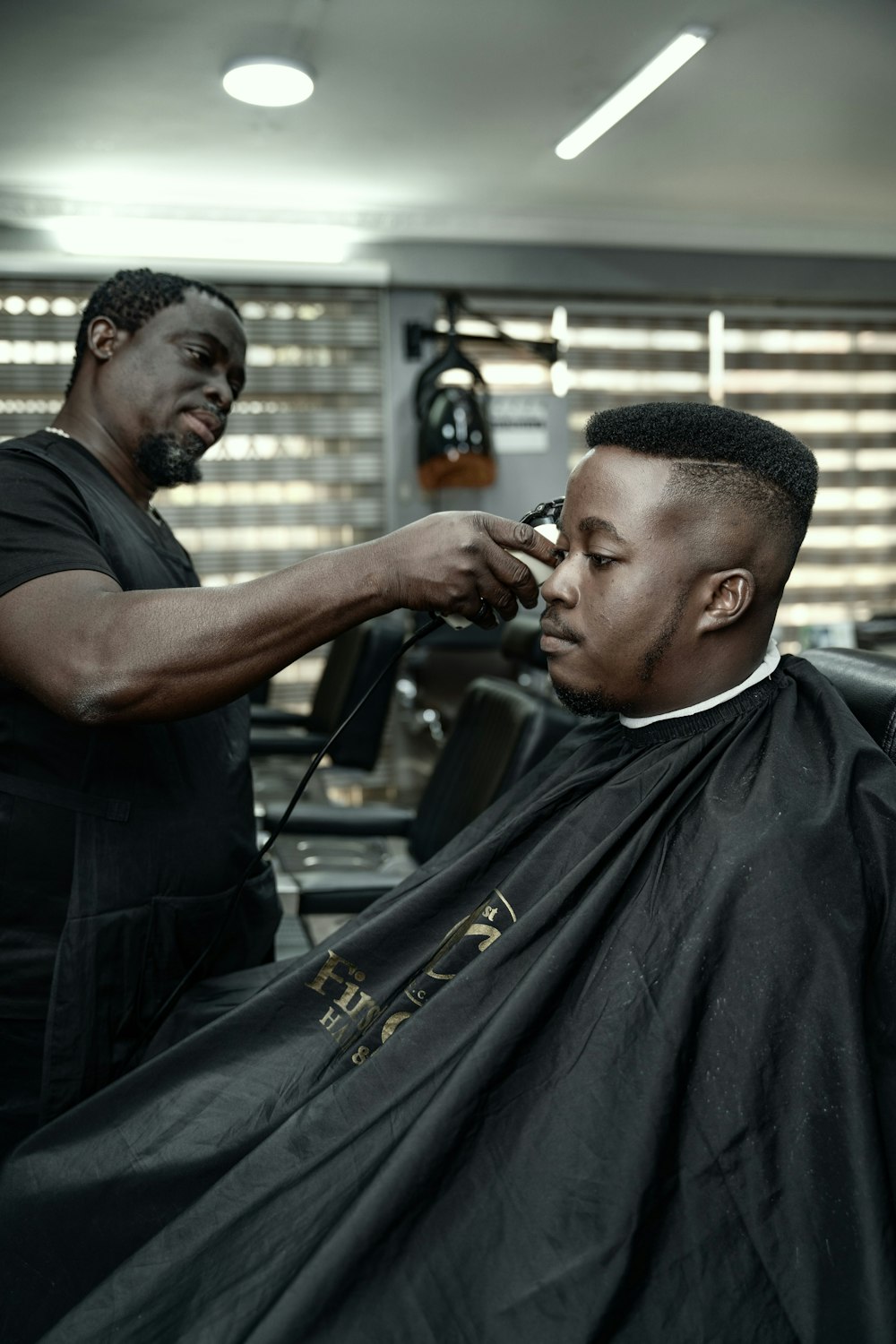 a man getting his hair cut by a barber