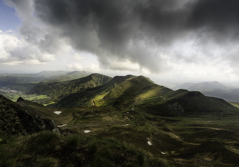 a view of a mountain range under a cloudy sky