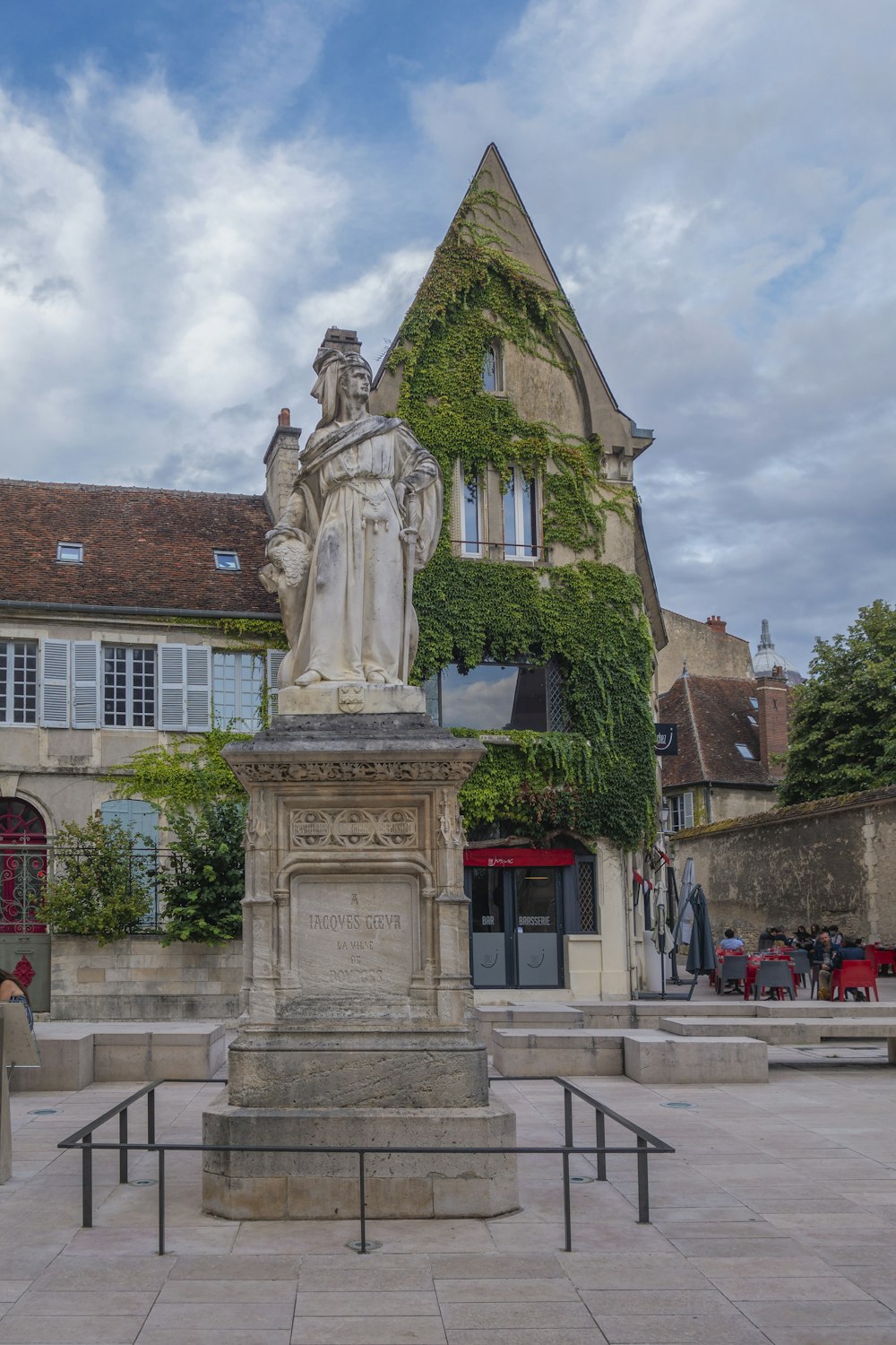 a statue of a woman in front of a building