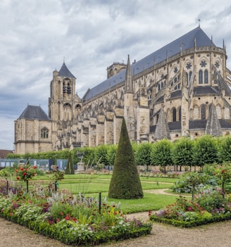 a large building with a garden in front of it