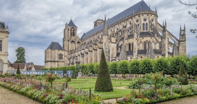 a large building with a garden in front of it