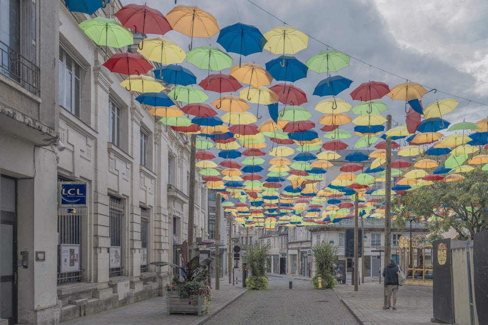 a bunch of colorful umbrellas hanging from the ceiling