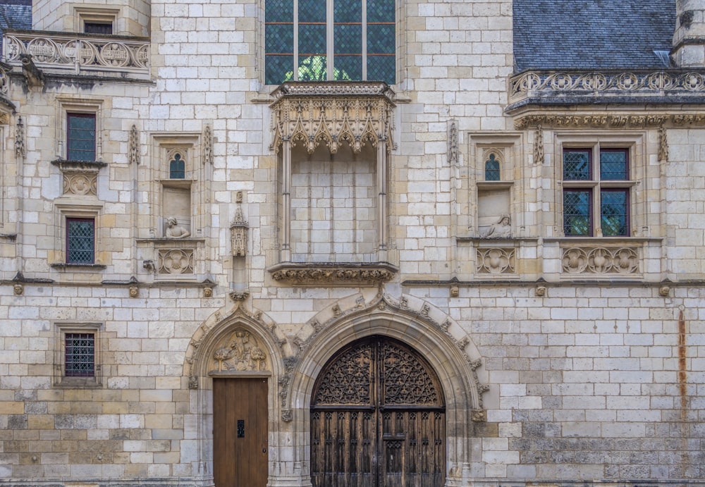 un grand bâtiment en pierre avec une porte en bois