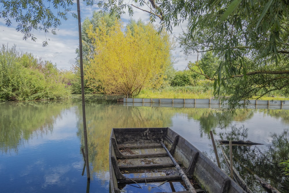 a wooden boat sitting on top of a river