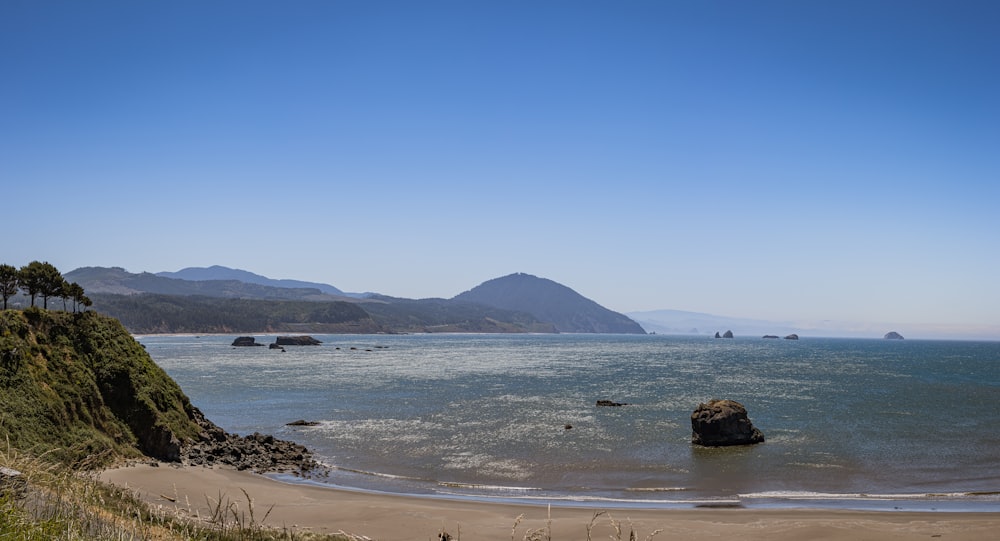 a view of a body of water with mountains in the background