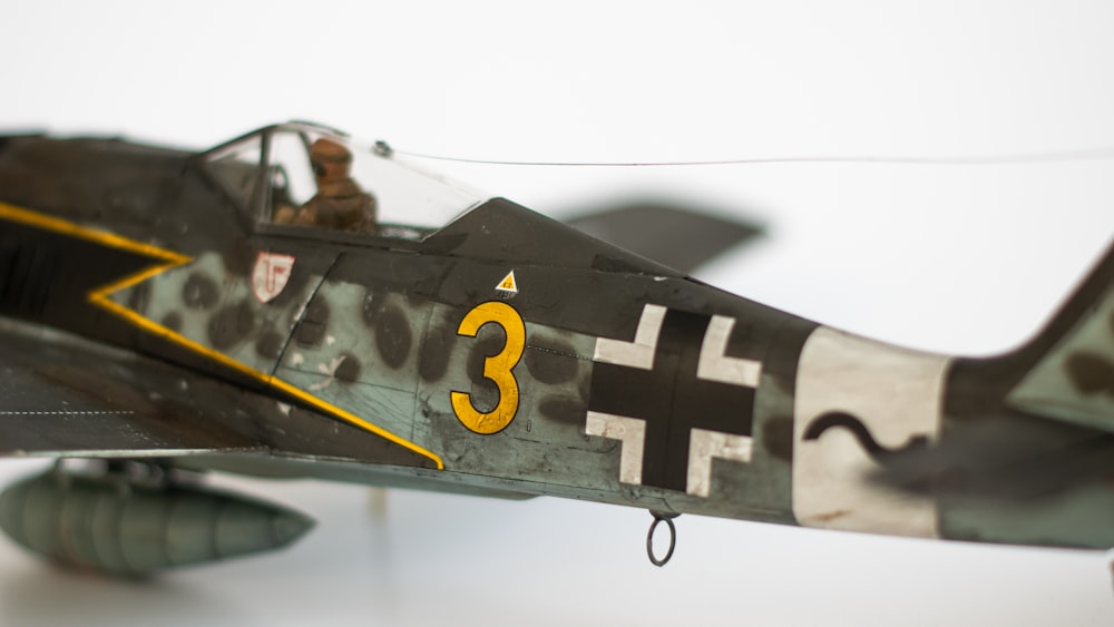 a model of a fighter plane on a white surface