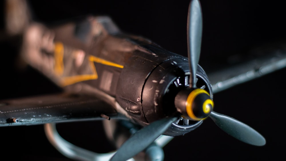 a close up of a model airplane on a black background