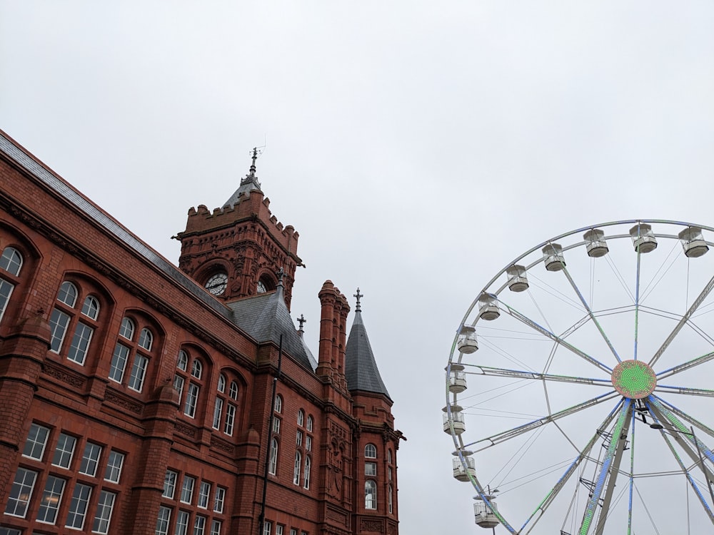 a large building with a ferris wheel in front of it