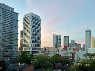 City skyline with modern high-rise buildings at sunset.