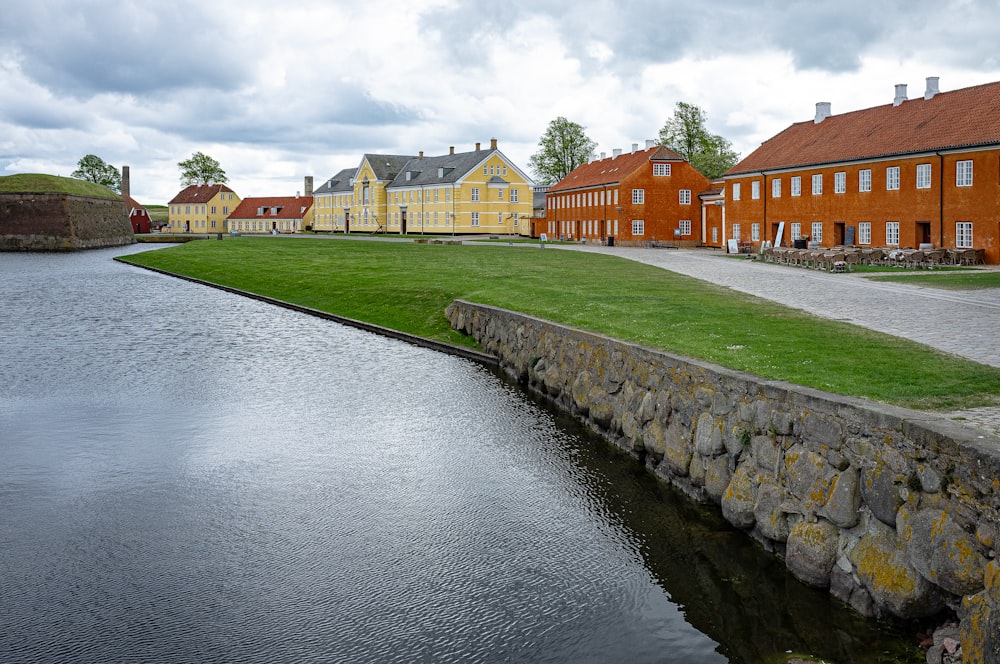 a row of houses next to a body of water