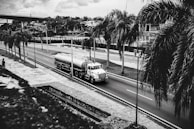 Minimalist photo of a sleek truck carrying a caçamba on a paved road