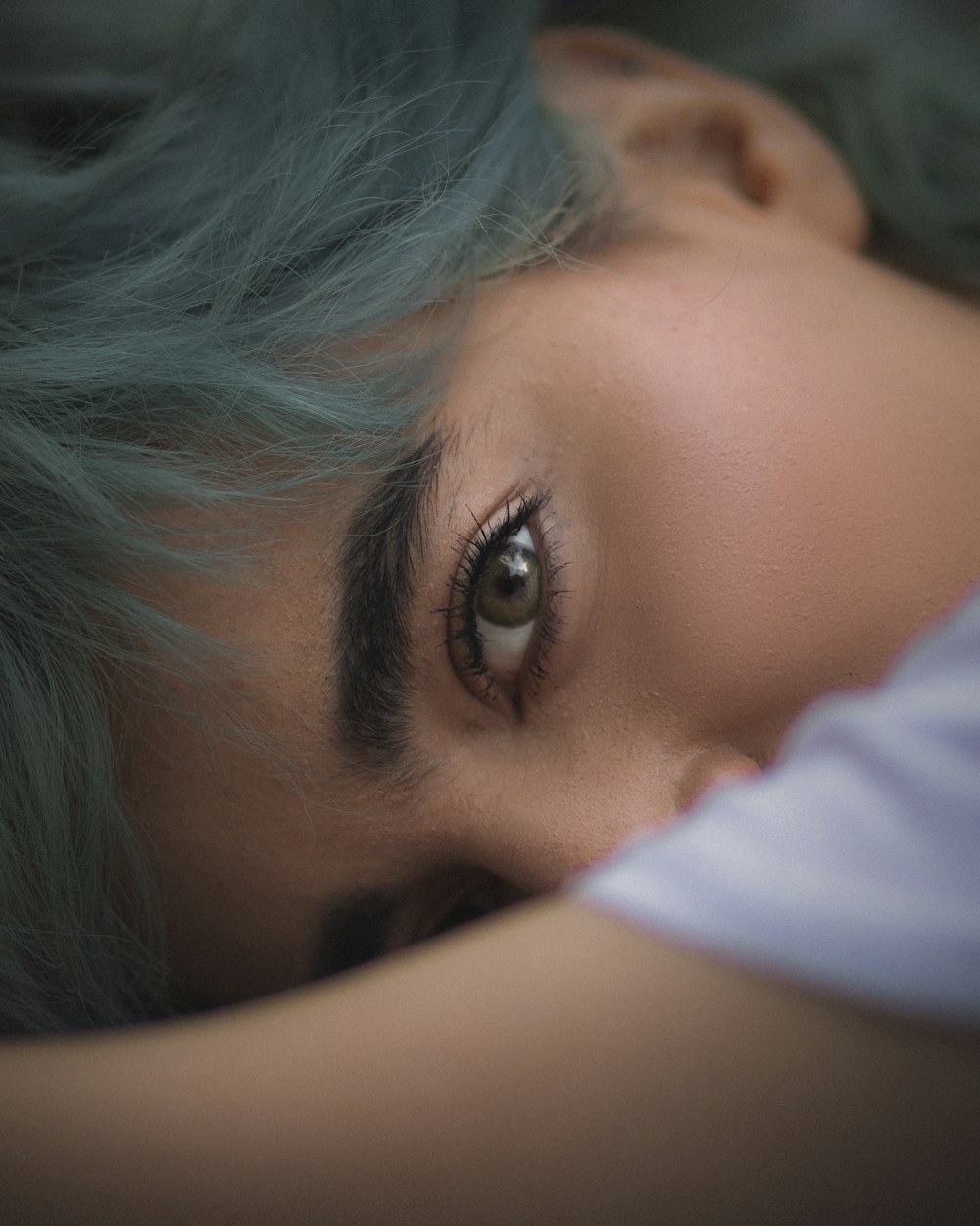 a close up of a person with green hair