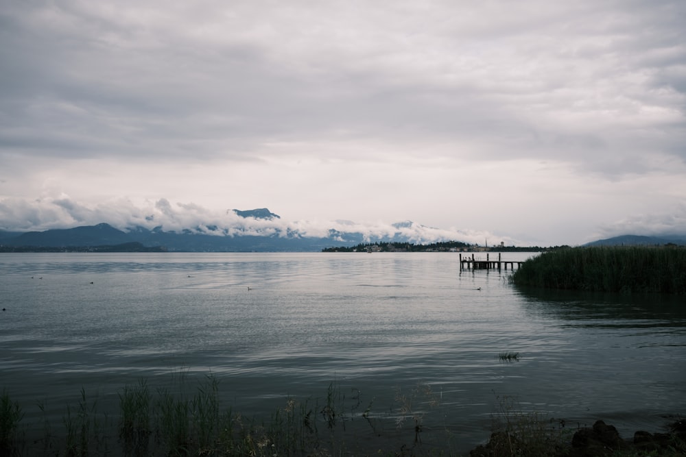 a body of water with a dock in the middle of it