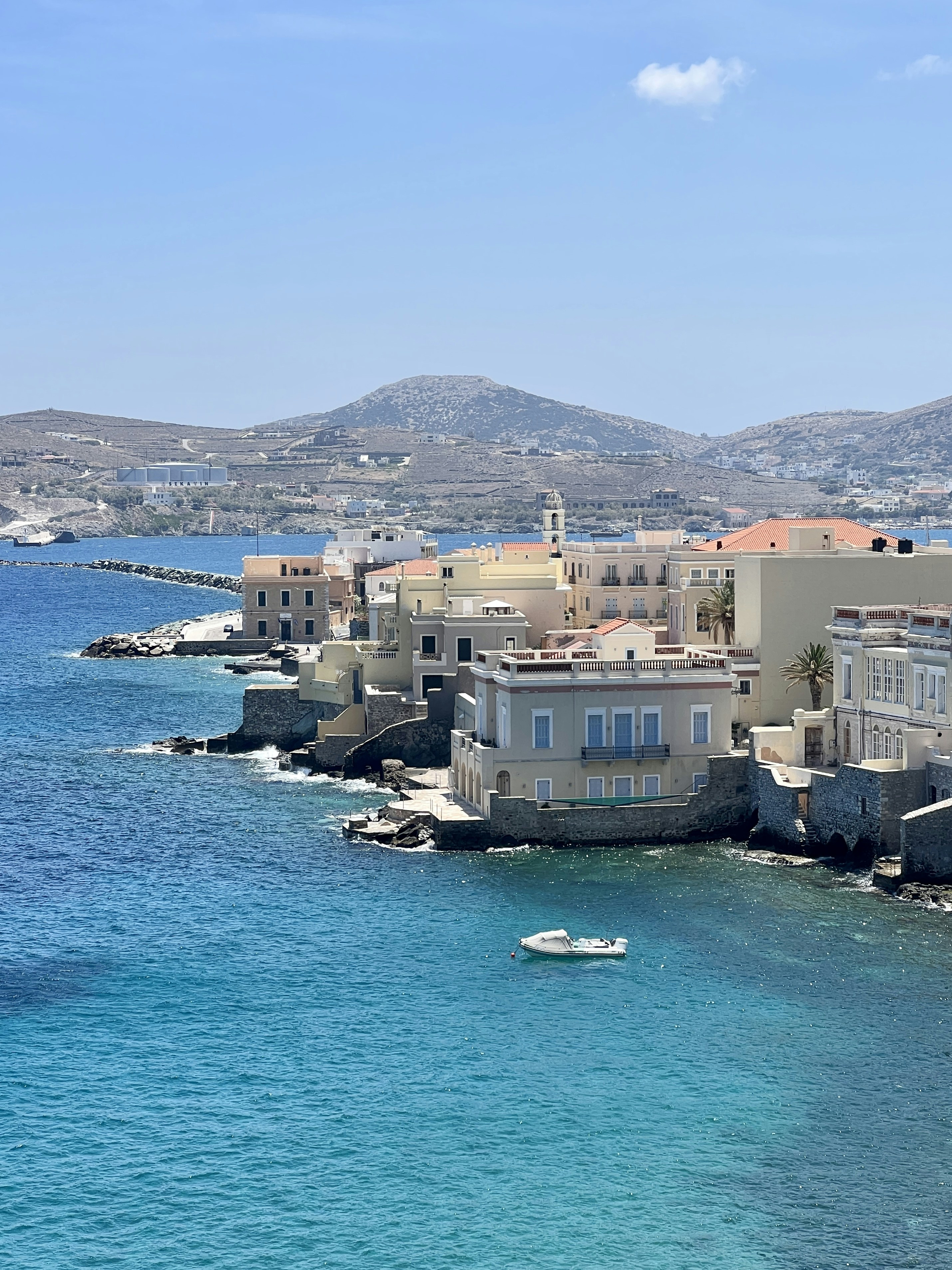 a body of water with buildings and a boat in the water