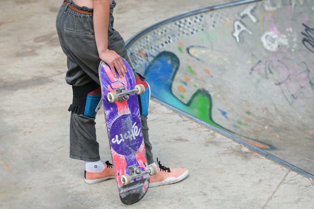 a person standing next to a skateboard in a skate park