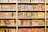 A bookshelf filled with numerous manga volumes organized neatly in rows. Each book is vividly colored, featuring different styles of artwork typical of Japanese manga. The spines display a variety of titles, characters, and symbols, creating a lively and engaging visual experience.