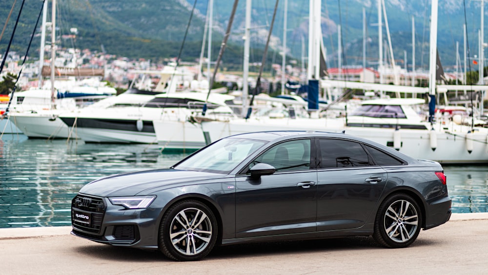 a grey car parked in front of a marina